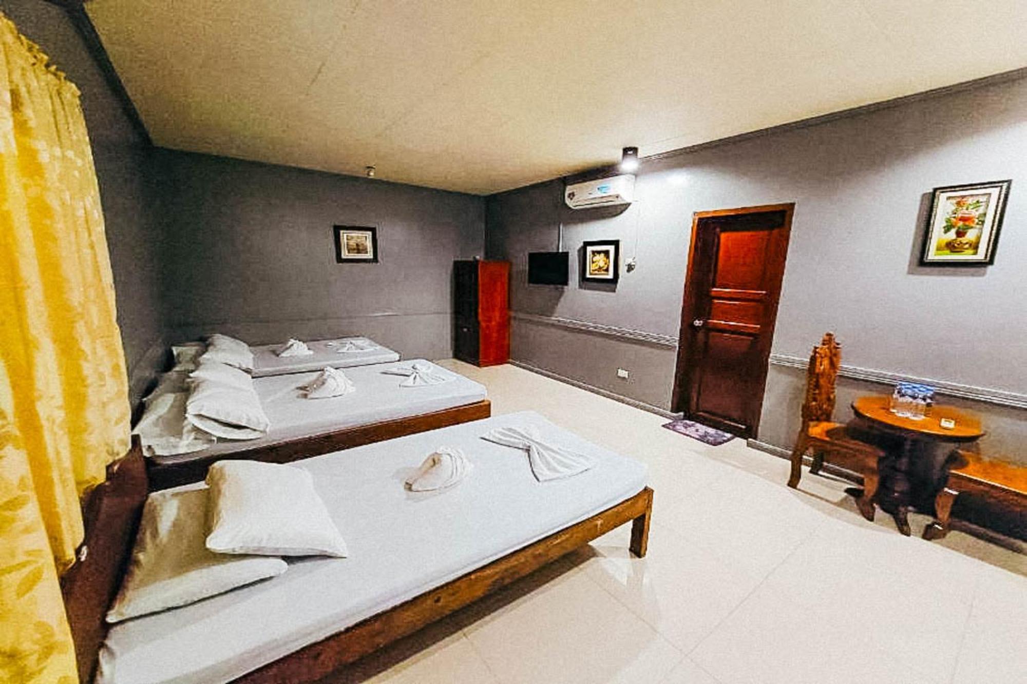 Mbg Travellers Inn Powered By Cocotel Puerto Princesa Habitación foto
