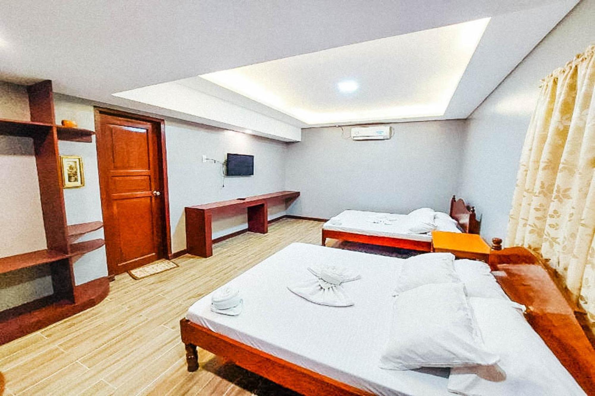 Mbg Travellers Inn Powered By Cocotel Puerto Princesa Habitación foto