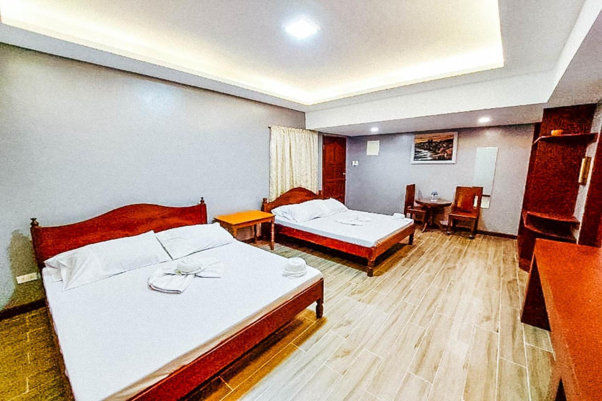 Mbg Travellers Inn Powered By Cocotel Puerto Princesa Habitación foto